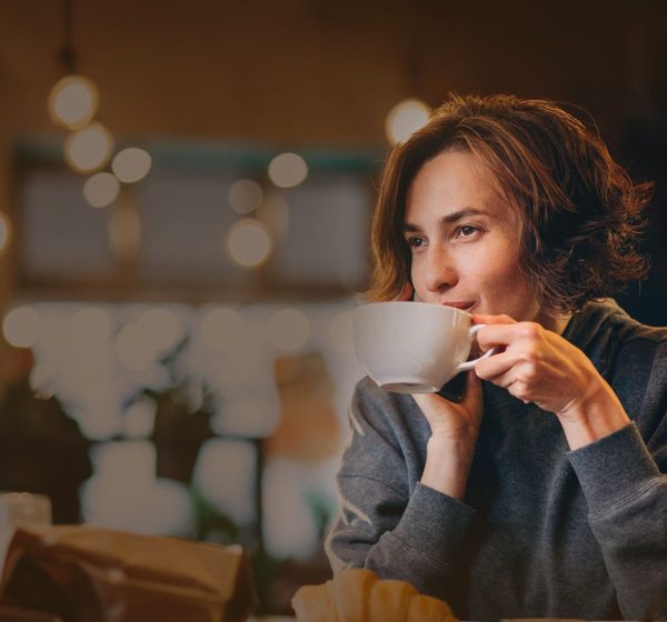 young-woman-eating-croissants-cafe2